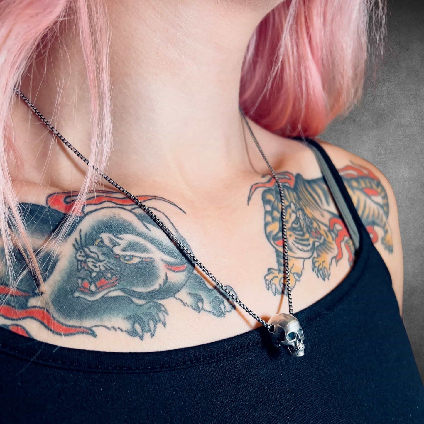 RESTING DEAD FACE sterling silver skull pendant on tattooed model.