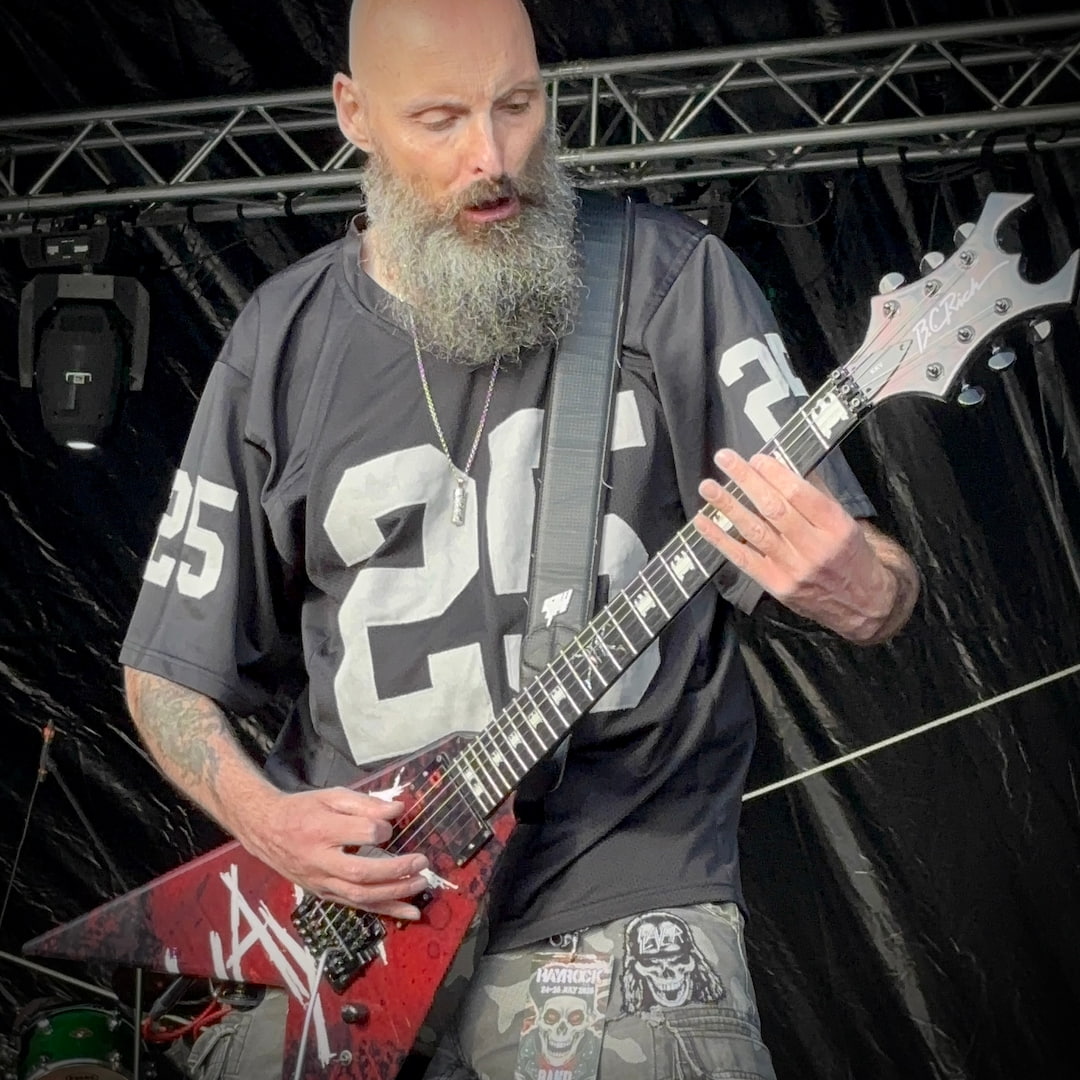 Stuart "Rage" Dixon performing with Live Undead, wearing the ROCKSTAR★REFINEMENTS™ 'ANTIDOTE (NOT INCLUDED) pendant on stage.