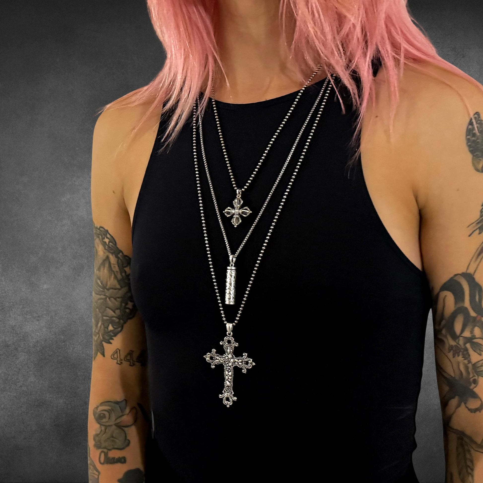 THE OUTLAW'S CROSS worn in a layered look with ALTAR EGO and POISON IS THE CURE. Blessed be the pink-haired model.