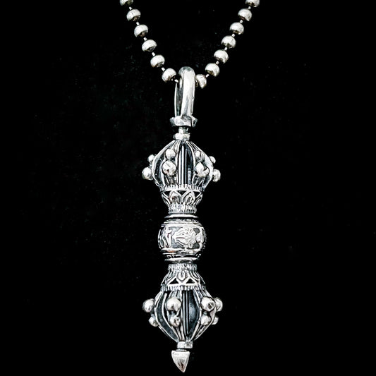 Close up shot of the WARBORN RELIC Sterling silver (possibly cursed) pendant on a ball chain, photographed on a black background