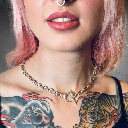 Close-up of a person with tattoos on their neck and shoulders wearing the TWIN LEAD sterling silver necklace by ROCKSTAR★REFINEMENTS™