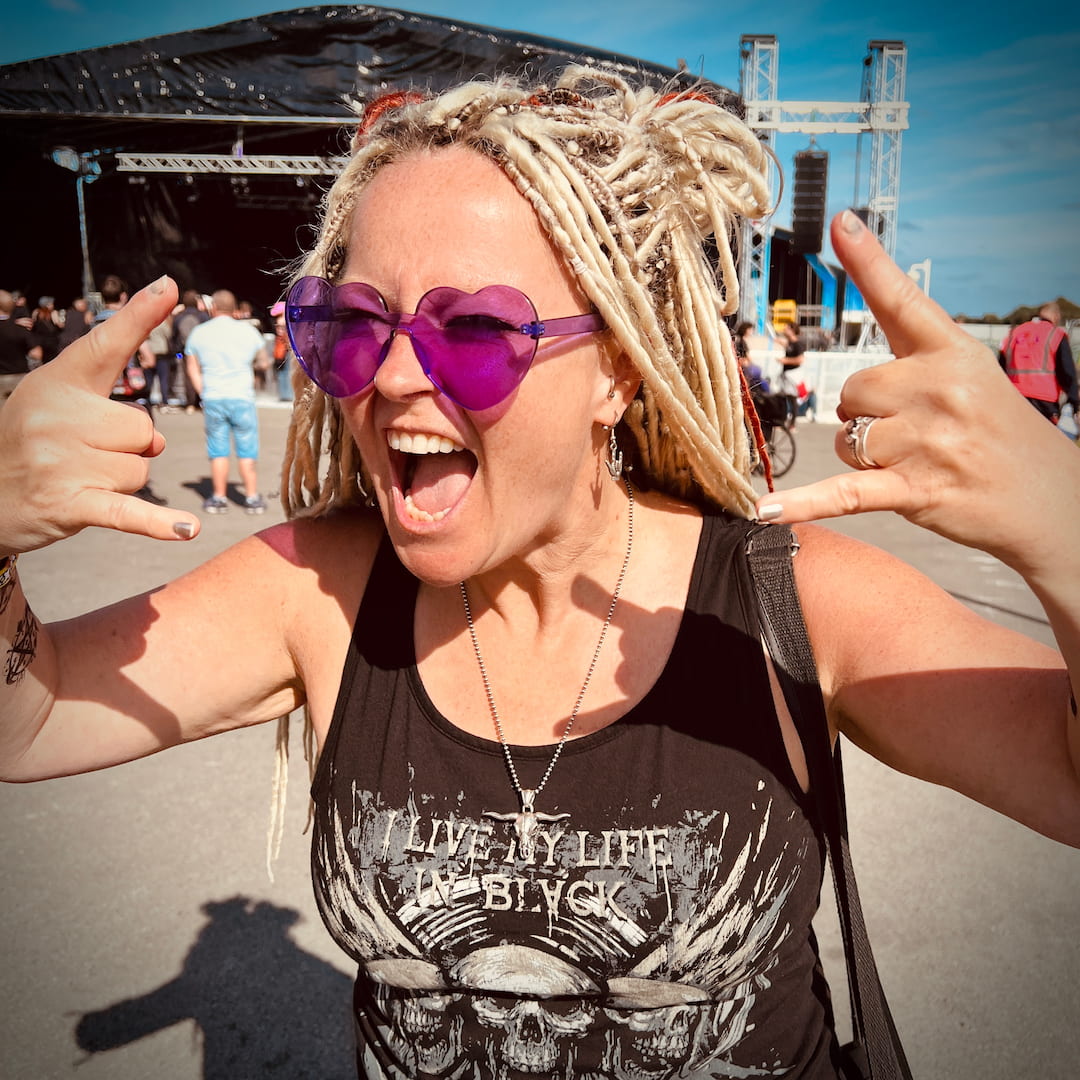 Festivalgoer wearing the ROCKSTAR★REFINEMENTS™ 'POINT OF NO RETURN' sterling silver bull skull pendant at an outdoor rock festival.