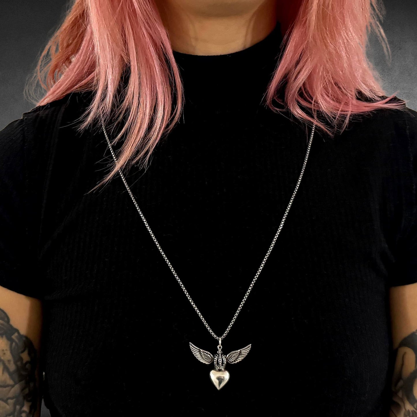 WILD AT HEART winged heart pendant on long sterling silver chain worn by model