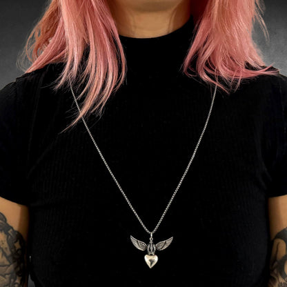 WILD AT HEART winged heart pendant on long sterling silver chain worn by model