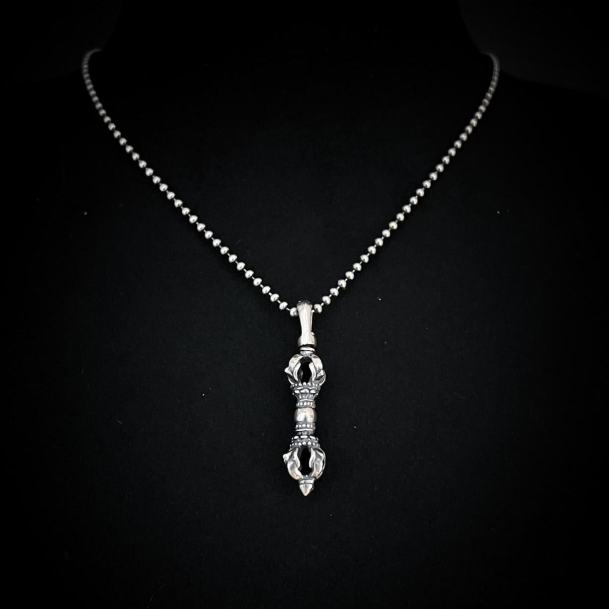 The WARBORN MINI on 18-inch ball chain, photographed on black background