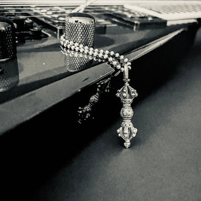 The WARBORN RELIC hanging off a Jackson KV2 guitar. Black and white photography.